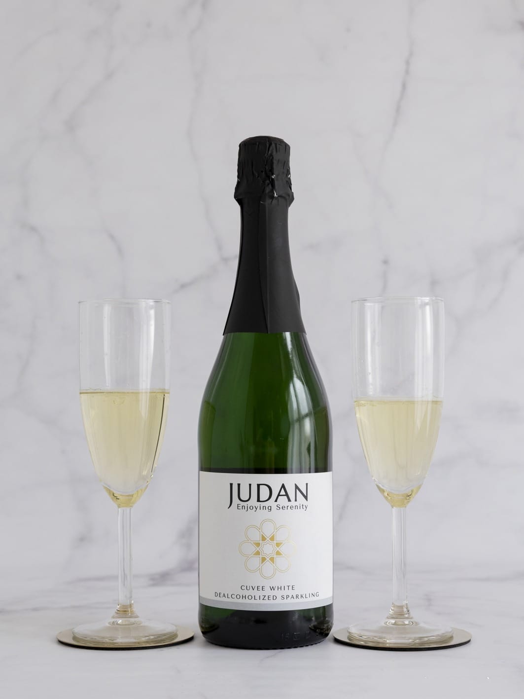 Botella de Cuvée White Judan con dos copas para un brindis con bebidas sin alcohol